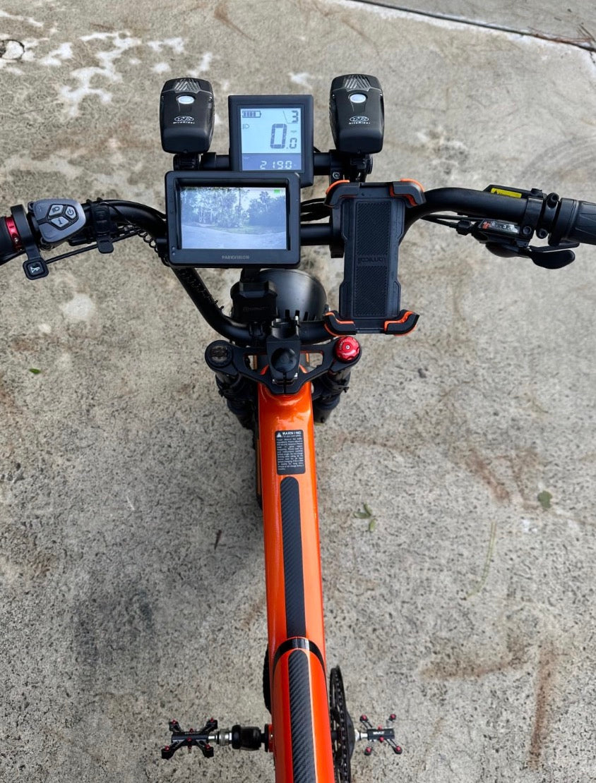 Rider climbing a steep hill on a fat-tire folding e‑bike
